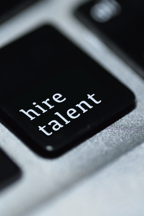 Board with key that says "hire talent"