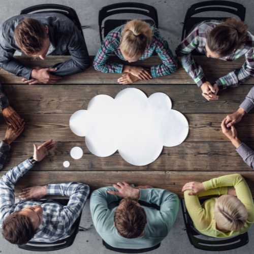 People around table, coming up with ideas